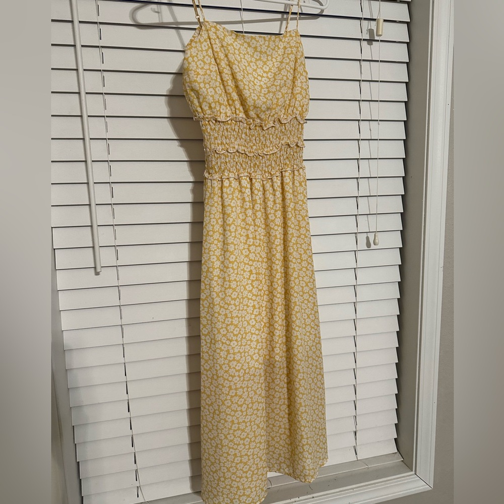 Shin length dress, yellow with white flowers, cinched on the top, ruffles